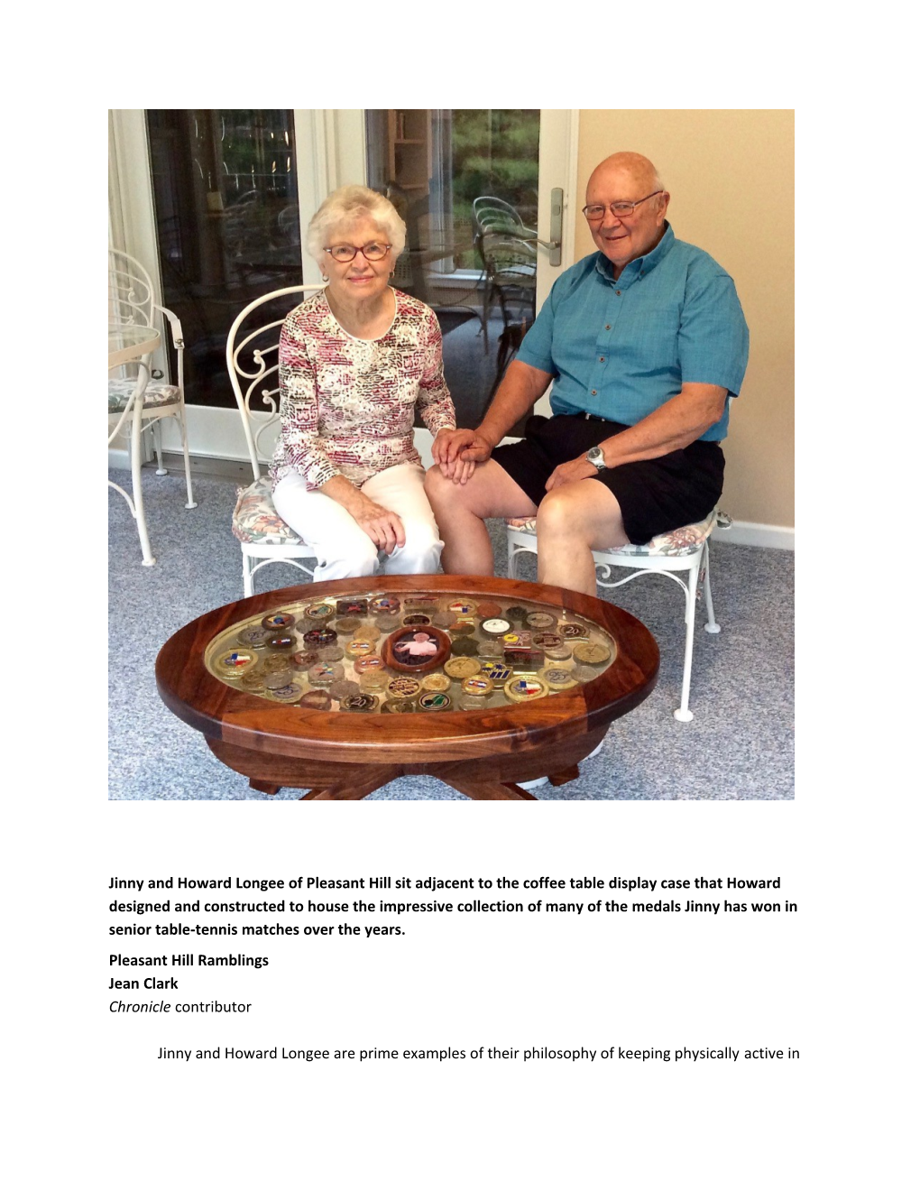 Jinny and Howard Longee of Pleasant Hill Sit Adjacent to the Coffee Table Display Case